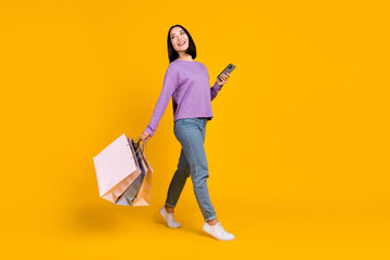 Poster - Full length photo of dreamy sweet woman wear violet shirt typing device shoppers looking empty space isolated yellow color background