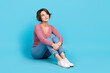 © deagreez - Full length portrait of cute minded person sit floor look empty space contemplate isolated on blue color background