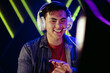 © Jacob Lund - Male gamer looking at his pc screen with a smile, pleased with his performance