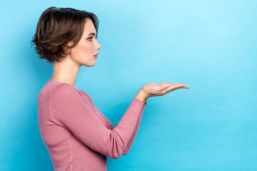 Poster - Profile photo of serious calm person look arms palms hold empty space isolated on blue color background