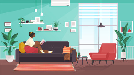 Woman reading book, sitting on sofa. Hobby, relax, resting, at home concept. Cute girl relaxes, doing favorite thing. Introvert reading interesting book in living room interior with homeplants