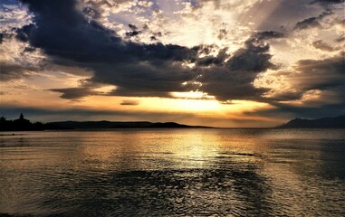 Wall Mural - Sunset above the sea with dramatic clods