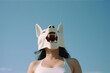 a girl in a dog mask on a blue background