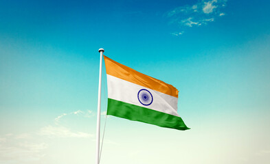 Waving Flag of India in Blue Sky. The symbol of the state on wavy cotton fabric.