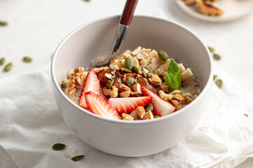 Wall Mural - Portion of healthy oatmeal porridge with strawberries and banana
