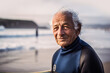 © ADDICTIVE STOCK - Generative AI image of portrait of smiling senior male with gray hair and in swimsuit looking at camera while standing on sandy beach near sea in evening
