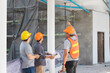 © skarie - Team of architect working together in building construction site. They discussing about new startup project. Engineer, foreman, Architect, contractor and worker in building construction site.