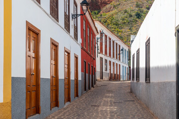 Wall Mural - Colored doors and windows to the streets in the village of Agulo in the north of La Gomera in summer, Canary Islands