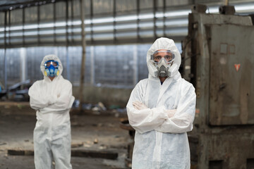 Chemical leak and safety first concept. Group of chemical specialist wear safety uniform, gas mask working in chemical dangerous area in the industry factory