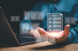 © NongAsimo - Document control and management concept, Businessman review procedures through the use of laptops and show digital checklist documents in hand technology on digital document paperless operation