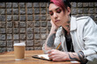 © Jorge Elizaquibel - Androgynous male writing on notepad on coffee break.