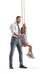 Canvas Print - Happy father smiling and standing behind a girl on a swing