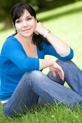 Poster - attractive woman relaxing on grass in park