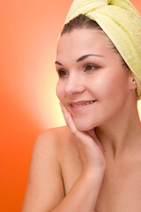 Wall Mural - attractive and fresh brunette woman on orange background