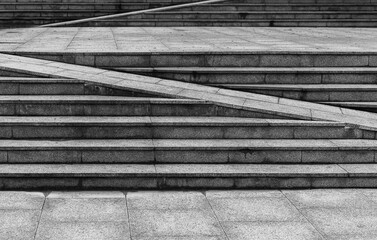 Outdoor urban granite stairs with a ramp,