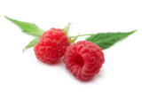 Fototapeta  - Two raspberries with green leaves on white background