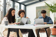 © Prostock-studio - Three Multiethnic Coworkers Working Using Laptops At Table In Office