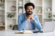 © Prostock-studio - Modern Freelancer. Happy Millennial Indian Man Sitting At Desk With Laptop