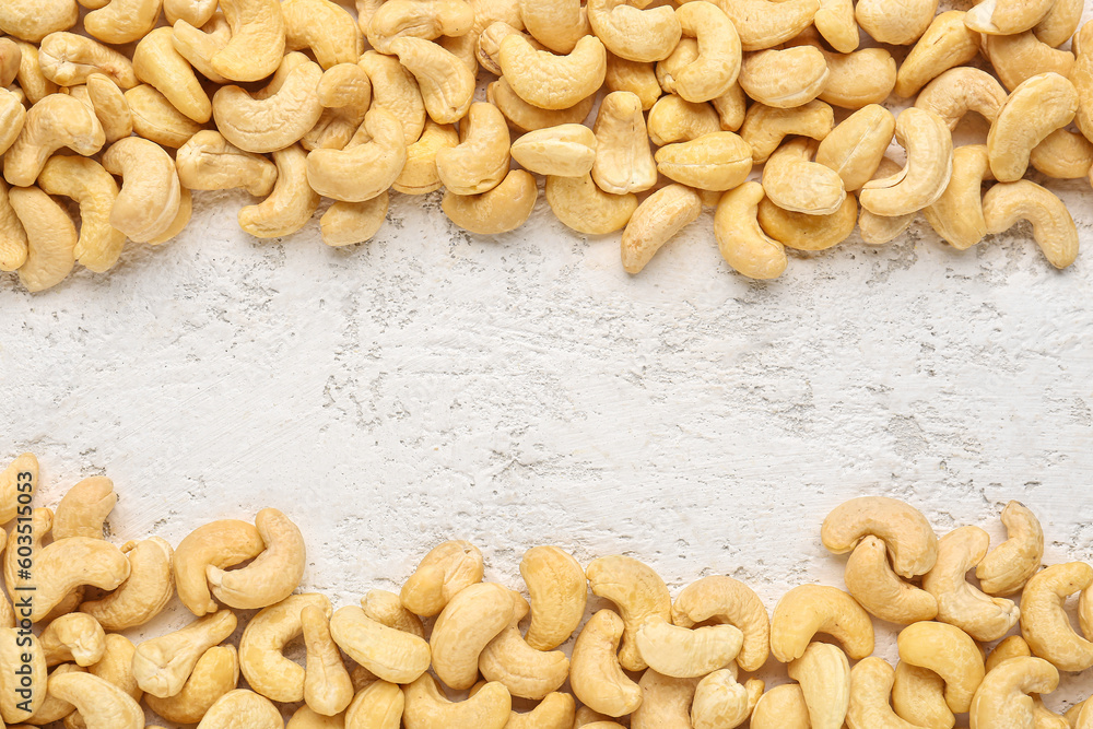 frame made of cashew nuts on light background