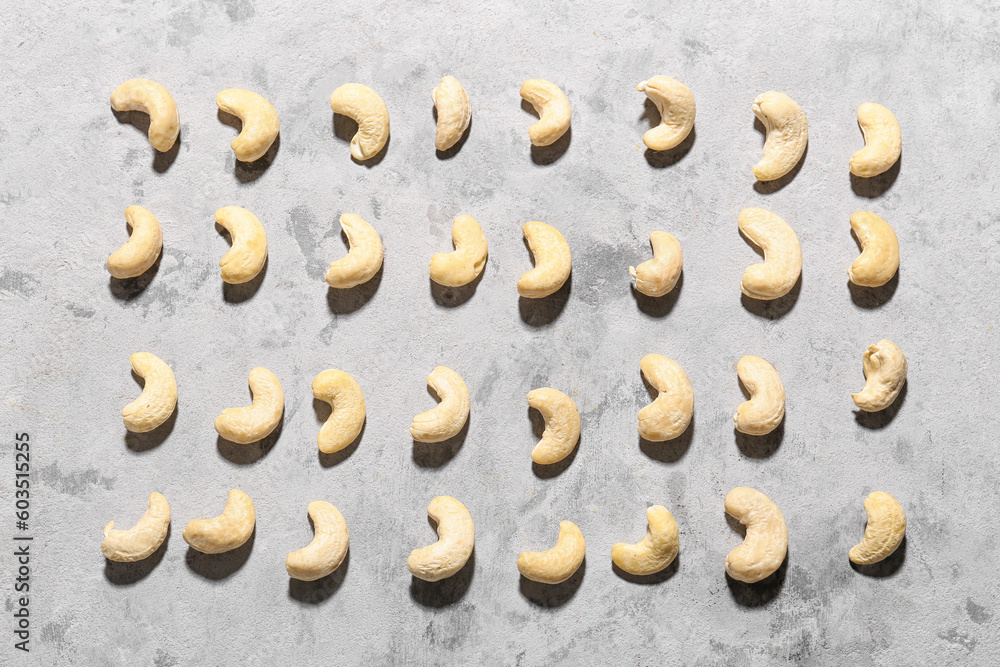 Tasty cashew nuts on grunge background