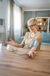 © Miljan Živković - Senior caucasian woman check blood pressure measure device on hand