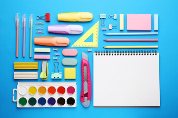 Wall Mural - Different school stationery on light blue background, flat lay. Back to school