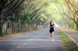 © noizstocker - young woman relax in garden road evening ,woman fitness silhouette sunrise jogging workout wellness concept.