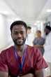 © wavebreak3 - Portrait of happy african american male doctor with arms crossed over diverse colleagues