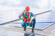 © chokniti - Male professional engineer installing solar photovoltaic panel system, Electrician mounting blue solar module technology on power industrial factory roof, Alternative energy ecological technician job