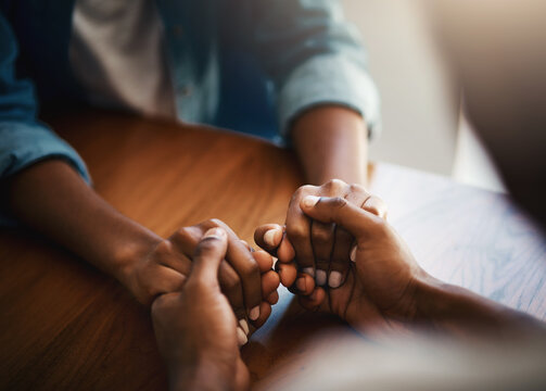 Empathy, prayer and support with friends and holding hands for comfort, kindness and gratitude. Hope, help and trust with closeup of people at home for depression, praying and forgiveness