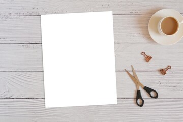 Blank paper sheet US letter size mockup for printable product, worksheet, coloring page, template, top view flat lay composition with scissors and coffee cup.