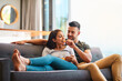 © N Hiraman/peopleimages.com - Love, happy couple on sofa and eating chips in living room of their home. Caring or bonding together, relaxing or comfortable and happy married people on couch watching television for quality time.