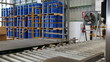 © supakitmod - Drums holding 200 liters of chemicals are filled on a line. Inside the warehouse, stacks of blue barrel chemical barrels are waiting to be delivered to customers' orders.