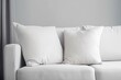 © Neda Asyasi - White square canvas pillow mockup on cozy couch. Beautiful white pillow mockup with modern interior background.
