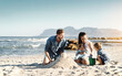 © Stratford/peopleimages.com - Sandcastle, happy summer and children at the beach with bonding, love and support. Baby, mom and dad together with kids playing in the sun with mockup space and smile by the ocean and sea with family