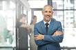 © Diane Munro/peopleimages.com - Businessman, portrait smile and arms crossed in leadership or team management at the office. Happy and confident man person, manager or corporate CEO executive smiling in small business confidence