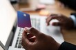 © Studio Marmellata - Unrecognizable male using modern laptop while entering credit card credentials into computer during online shopping