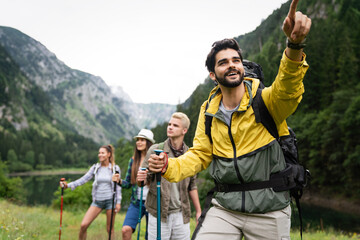 Wall Mural - Hiking with friends is so fun. Group of young people with backpacks together