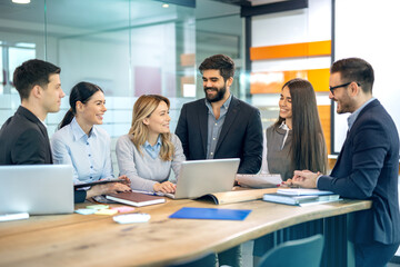 Wall Mural - Successful strategy team discussing how to most effectively use a company's resources to meet specific goals and objectives.