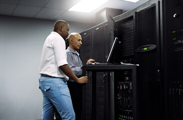 server room, people or technician coding on computer together for a cybersecurity glitch with teamwo