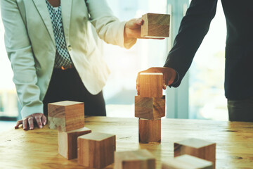 Poster - Teamwork, man and woman in office with building blocks, design ideas and problem solving challenge. Engineering, planning and strategy, wood block game and team of business people working together.
