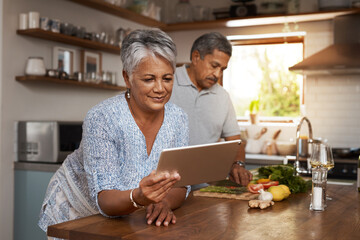 Wall Mural - Internet, old woman at kitchen counter with man and tablet, cooking healthy food together in home. Digital recipe, health and senior couple with meal prep, happiness and wellness diet in retirement.