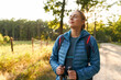 © baranq - Adult woman relaxing in forest taking big breath enjoying sunny summer countryside walk countryside