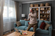 © Srdjan - Senior happy man dancing in living room at home with music on laptop and wireless headphones, celebrating retirement and finishing work. Elderly pensioner male dance