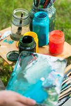 Jars Of Coloured Paint And Pallet For Mixing