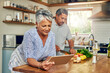 © Tamani Chithambo/peopleimages.com - Senior woman at kitchen counter with man, tablet and cooking healthy food together in home. Digital recipe, smile and old couple in house with meal prep, happiness and wellness diet in retirement.