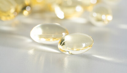 Wall Mural - Vitamin D yellow supplement gel capsules, Fish Oil Omega 3 on white background, macro shot 