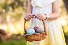 Child Holding Out Basket Of Speckled Easter Eggs