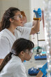 © BalanceFormCreative - Group of female chemistry scientists doing experiments in the lab.