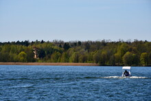 A View Of A Motor Boat Quickly Traversing A Small Yet Deep Lake Or River With Some Other Vessels Visible In The Background Spotted On A Sunny Summer Day On A Polish Countryside Near The Coast